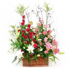Red and Pink Roses with Lilies and Greenery in a Basket