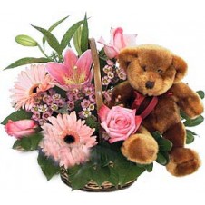 Round Arrangement of Pink Flowers in a Basket with Added Teddy Bear